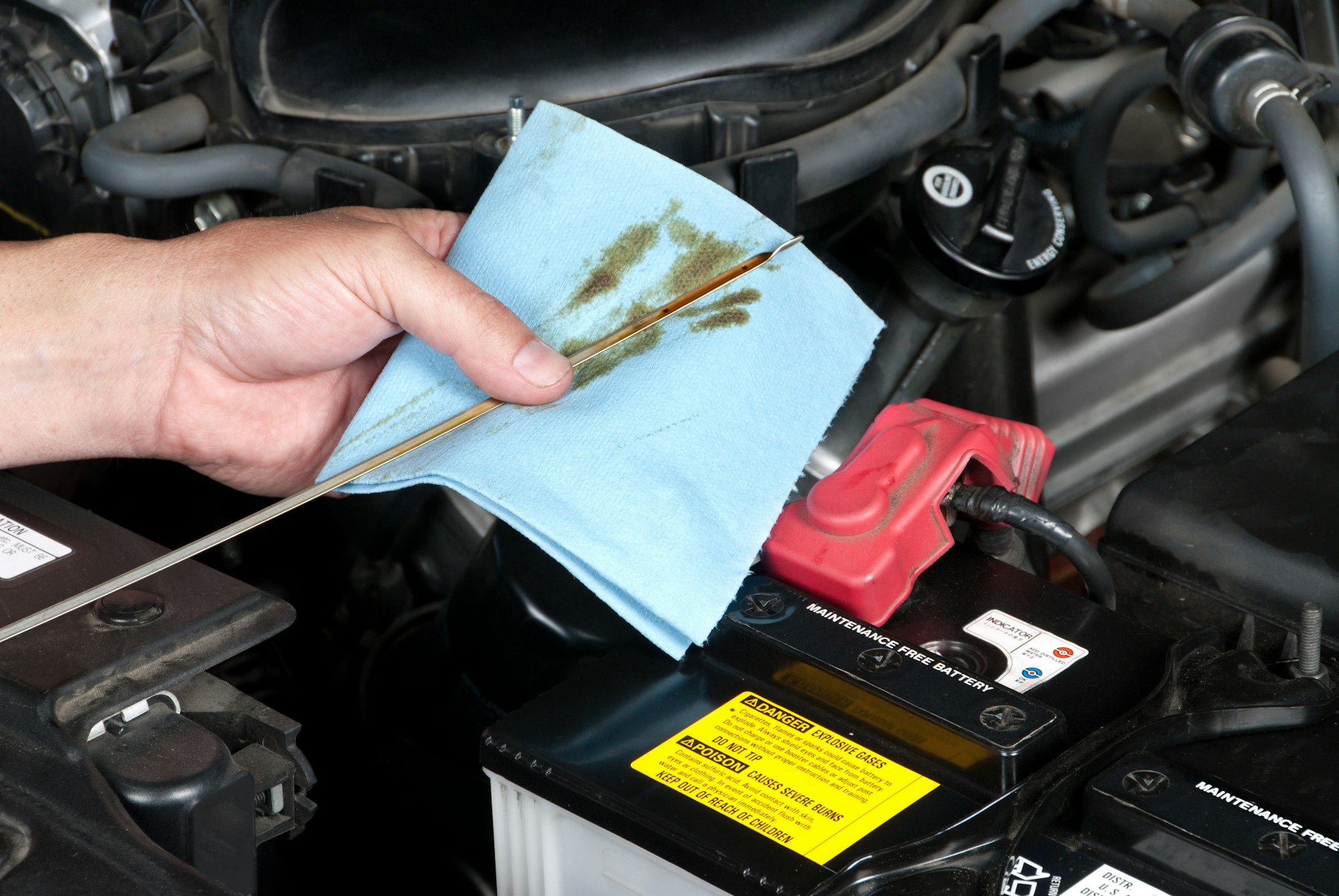 Auto Mechanic Checking Oil