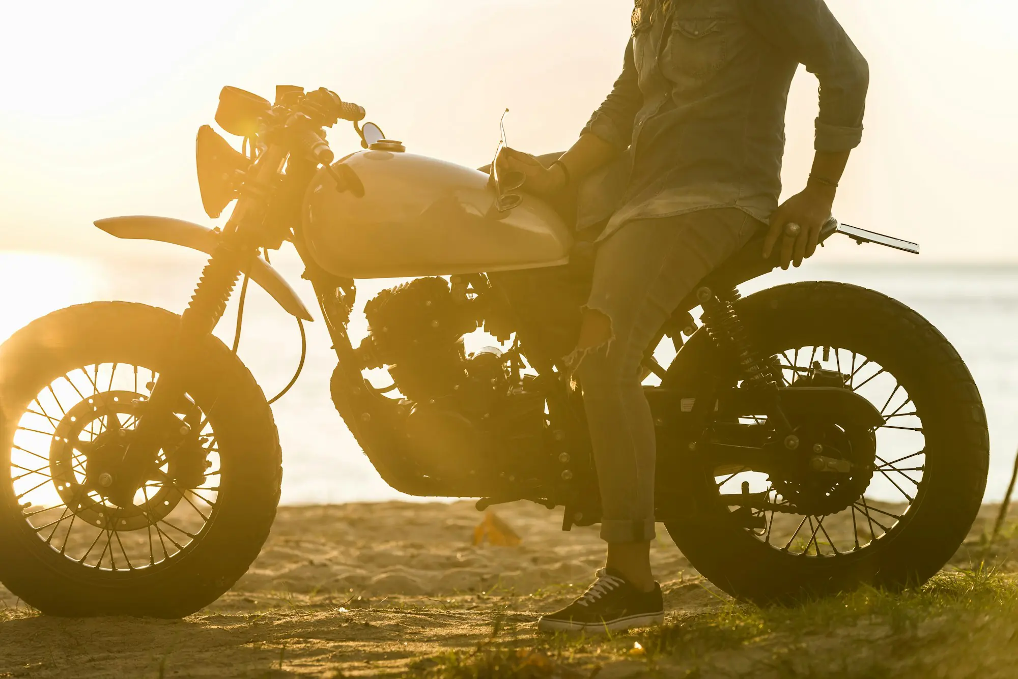 Female biker driving a cafe' racer motorbike