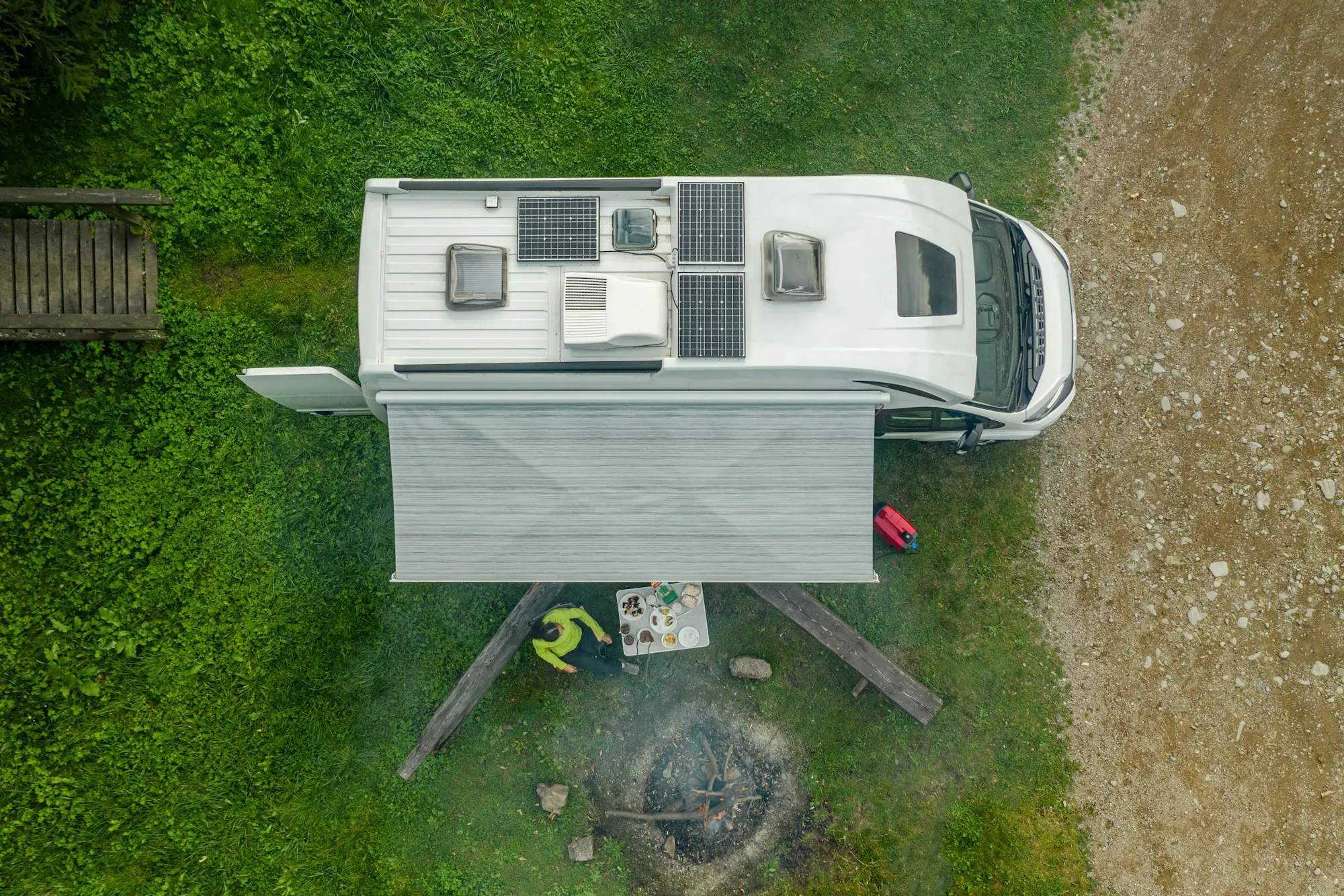 RV Park Pitch with Camper Van and Campfire Place Aerial View